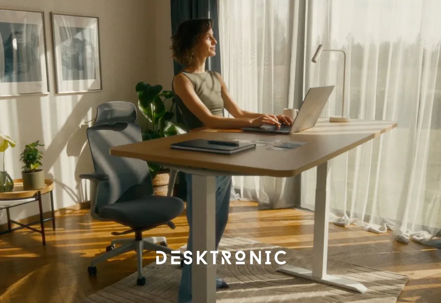 Desktronic HomePro standing desk and SitPro chair in a bright home office setup